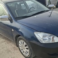 لانسر ٢٠١٠ ٤ قطع صبغ  كير مكينه تبريد كامله السعر ٧٣  07729658633