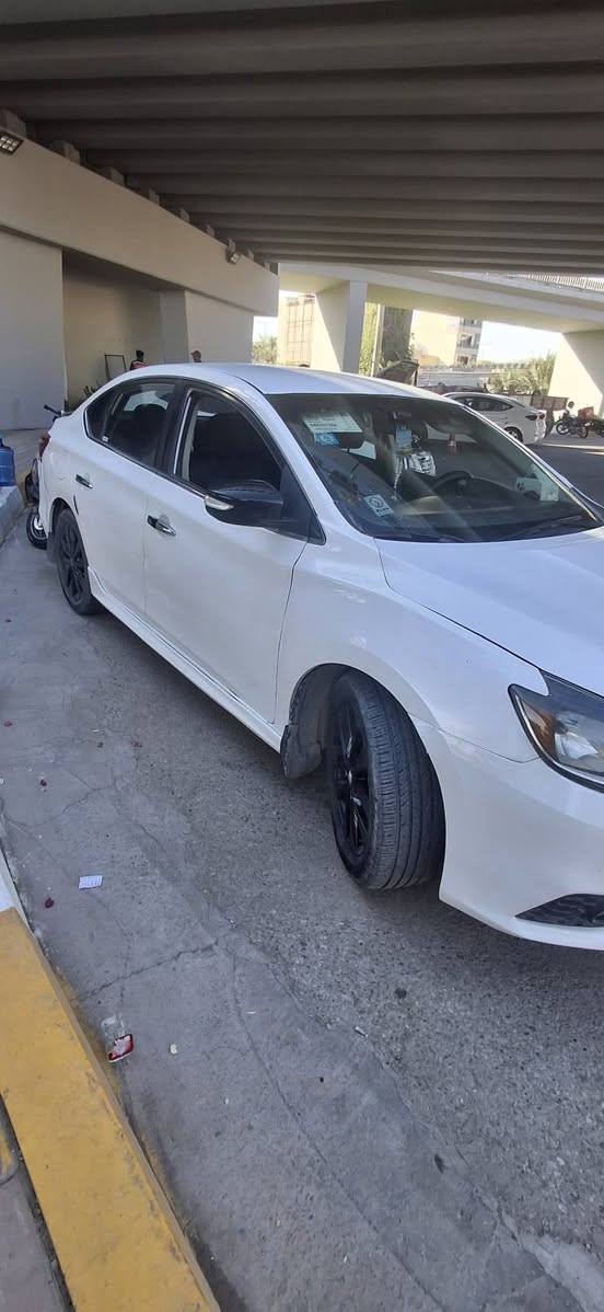 🚗 نيسان سنترا SR موديل 2018 للبيع 🚗
​نوع السيارة: نيسان سنترا (فئة SR السبورت).
​الموديل: 2018.
​اللون: أبيض صدفي مميز.
​ (الضرر): قطعتين فقط (بنيد وجاملغ)، وباقي التفاصيل حسب تقرير الفحص.
​المواصفات:
​مظهر رياضي (فئة SR) مع جناح (سبويلر) خلفي بلون أسود بلادي.
​ويل تراك  سبورت بلون أسود مميز.
​السيارة بحالة جاهزة ونظيفة جداً كما موضح بالصور.
​📍 مكان الانبار الرمادي الخالديه 
​السعر المطلوب: 115 ورقة وبيه مجال قليل للشراي 
​ / 
 والاستفسار: يرجى الاتصال على الرقم: 📞 ***********
