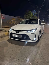 كورلا خليجي هايبرد فول 1/1 ماشيه10الف بس  رقم بغداد  موديل 25 محرك 1.8...