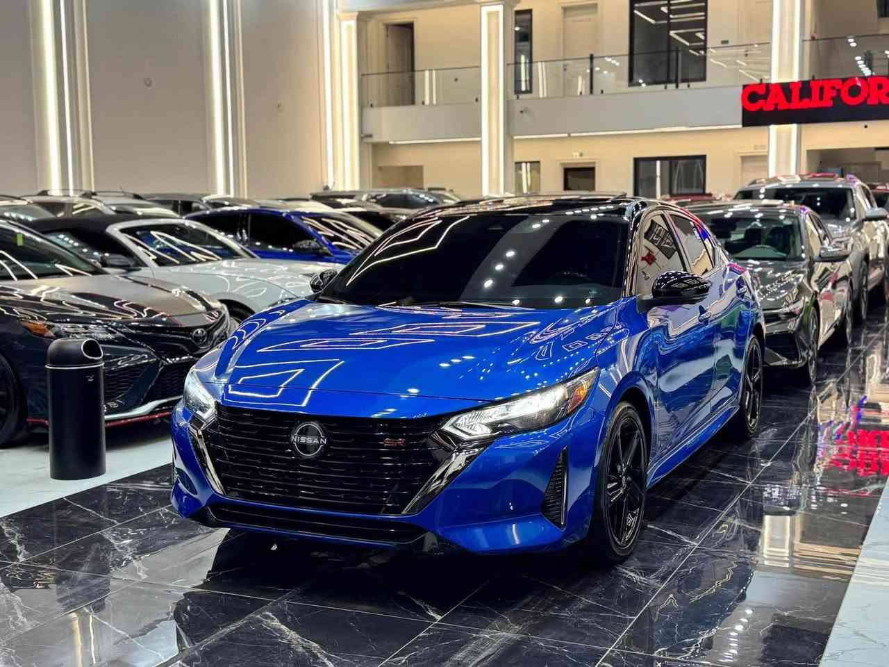 𝟐𝟎𝟐𝟒 𝐍𝐈𝐒𝐒𝐀𝐍 𝐒𝐍𝐓𝐑𝐀-𝐒𝐑.𝐏𝐋𝐔𝐒

نيسان سنترا (𝐒𝐑.𝐏𝐋𝐔𝐒) موديل : 2024

اللون :ازرق مميز سقف اسود بيلادي

عداد المسافة : 674 زيـــرو

حجم المحرك : 2.0L (4.سلندر)

ملاحظة السيارة : فقط ربع جاملغ صبغ بدون دواخل 

كافة الايرباكات سليمة 100%

المواصفات : 𝐒𝐑.𝐏𝐋𝐔𝐒

فول فول مواصفات 1/1

فتحة سقف سلايد 
 بصمة ابواب 
بصمة تشغيل 
تشغيل عن بعد (𝐑𝐄𝐌𝐎𝐓𝐄 𝐒𝐓𝐀𝐑𝐓)
سستم سماعات 🔊 (𝐁𝐎𝐒𝐄)
شاشة دشبول ديجيتال
شحن وايرليس
كاميرا °360
‏‎كاميرا امامي
كاميرا جانبي
كاميرا خلفي
اوتو ستارات (𝐀𝐔𝐓𝐎 𝐒𝐓𝐀𝐑𝐓)
اوتو ستوب (𝐀𝐔𝐓𝐎 𝐒𝐓𝐎𝐏)
رادار امامي (تحديد مسار)
رادار جانبي  (نقاط عمياء)
رادار خلفي (التحذير من الاصطدام)
حساسات امامي
حساسات جانبي 
حساسات خلفي 
نظام (𝐄𝐂𝐎)
نظام (𝐍𝐎𝐑𝐌𝐀𝐋)
نظام (𝐒𝐏𝐎𝐑𝐓)
كشنات جلد
كشنات كهربائي
كشنات هيتر
تحكمات استيرن
استيرن هيتر
تبريد لمس 
تبريد مركزي 
لايتات ليـــLEDـــد عدسة زينون بيلادي
بكلايتات ايـــLEDـــد بيلادي
ويــــل كــــروم  

بعد هواية مواصفات…

‏‎تفاصيل اكثر الاتصال علی ارقام التاليه ‏

☎️***********

☎️***********

‏‎عنوان📍اربيل فرع ناقلات

معرض كاليفورنيا كارس CALIFORNIA Cars أربيل, العراق
