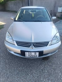 لانسر موديل ١١ رقم بغداد انكليزي بسمي سياره جديده محرك بلادي اسود تدفه...