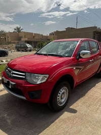 ميتسوبيشي L200 2013 مكفولة  185,000 km  تبريد /صدر جديد كير ومحرك بلاد...