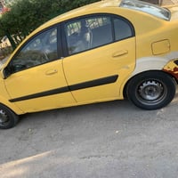 كيا ريو 2009 امريكي حادثها مثل مموضح بلصوره رقمها انبار  السياره جاهزه...