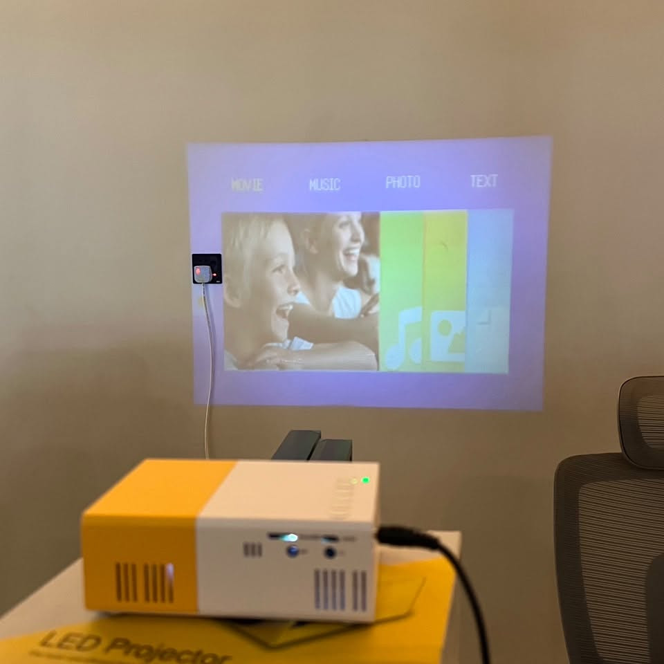بروجکتر (داتاشو)🔥📺
بروجكتر LED صغير محمول بدقة عرض مدعومة 1080P مع بطارية مدمجة ومنافذ HDMI / USB / Micro SD

• بروجكتر LED صغير ومحمول مناسب لعرض الفيديو والصور والموسيقى مباشرة من عدة مصادر مثل HDMI وUSB وMicro SD، مع دعم تشغيل الوسائط المتعددة.

• يدعم تشغيل فيديو بدقة تصل إلى 1080P مع دقة عرض أصلية 320×240 باستخدام تقنية TFT LCD وإضاءة LED بعمر يصل إلى 30,000 ساعة.

• يدعم عدة طرق تشغيل للطاقة عبر محول كهربائي 12V أو عبر Power Bank بخرج 5V/2A، كما يحتوي على بطارية ليثيوم مدمجة 7.4V / 1300mAh في الموديلات الداعمة.

• خيارات اتصال متعددة تشمل:
HDMI – USB – Micro SD – AV – منفذ سماعة 3.5 مم لربط السماعات أو الهيدفون.

• تشغيل الوسائط مباشرة من الفلاش أو بطاقة الذاكرة مع دعم ملفات الفيديو والصوت والصور والنصوص.

• حجم صغير وخفيف مع إمكانية عرض صورة من 24 إلى 60 إنش على مسافة عرض بين 1.5 إلى 2 متر.

• تقنية العرض: TFT LCD
• مصدر الإضاءة: LED
• عمر إضاءة LED: حتى 30,000 ساعة
• الدقة الأصلية: 320 × 240 بكسل
• الدقة المدعومة: 1920 × 1080 بكسل
• نسبة التباين: 800:1
• نسبة العرض: 4:3 / يدعم 16:9 في النظام
• عدد الألوان: 16.7 مليون لون

العرض والإسقاط
• مسافة العرض: 1.5 – 2 متر
• حجم العرض: 24 – 60 إنش
• نسبة الإسقاط: 1.6 : 1

الطاقة
• المحول: 12V / 2A
• دعم تشغيل عبر باور بنك: 5V / 2A
• بطارية مدمجة: Lithium 7.4V / 1300mAh
• استهلاك الطاقة: 10 – 24 واط

المنافذ
• HDMI
• USB
• Micro SD
• AV
• منفذ سماعة 3.5mm
• Micro USB (طاقة)

الوسائط المدعومة
• الصوت: MP3 / WMA / OGG / AAC / FLAC / APE / WAV
• الصور: JPEG / BMP / PNG
• الفيديو: 3GP / AVI / MKV / FLV / MOV / MP4 / MPG / VOB / RMVB / RM
• النصوص: TXT

النظام
• يدعم الوسائط: موسيقى – صور – فيديو – نصوص
• دعم لغات النظام: 23 لغة

الأبعاد
• حجم الجهاز: 126.4 × 85.8 × 47.7 مم

محتويات العلبة:
• جهاز LED Projector
• ريموت كنترول
• محول طاقة (Adapter)
• كابل AV
• دليل الاستخدام (Manual)


**إذا كنت صاحب هذا الإعلان وتريد حذفه لأي سبب، رجاءا أرسل رسالة إلى الدعم الفني**